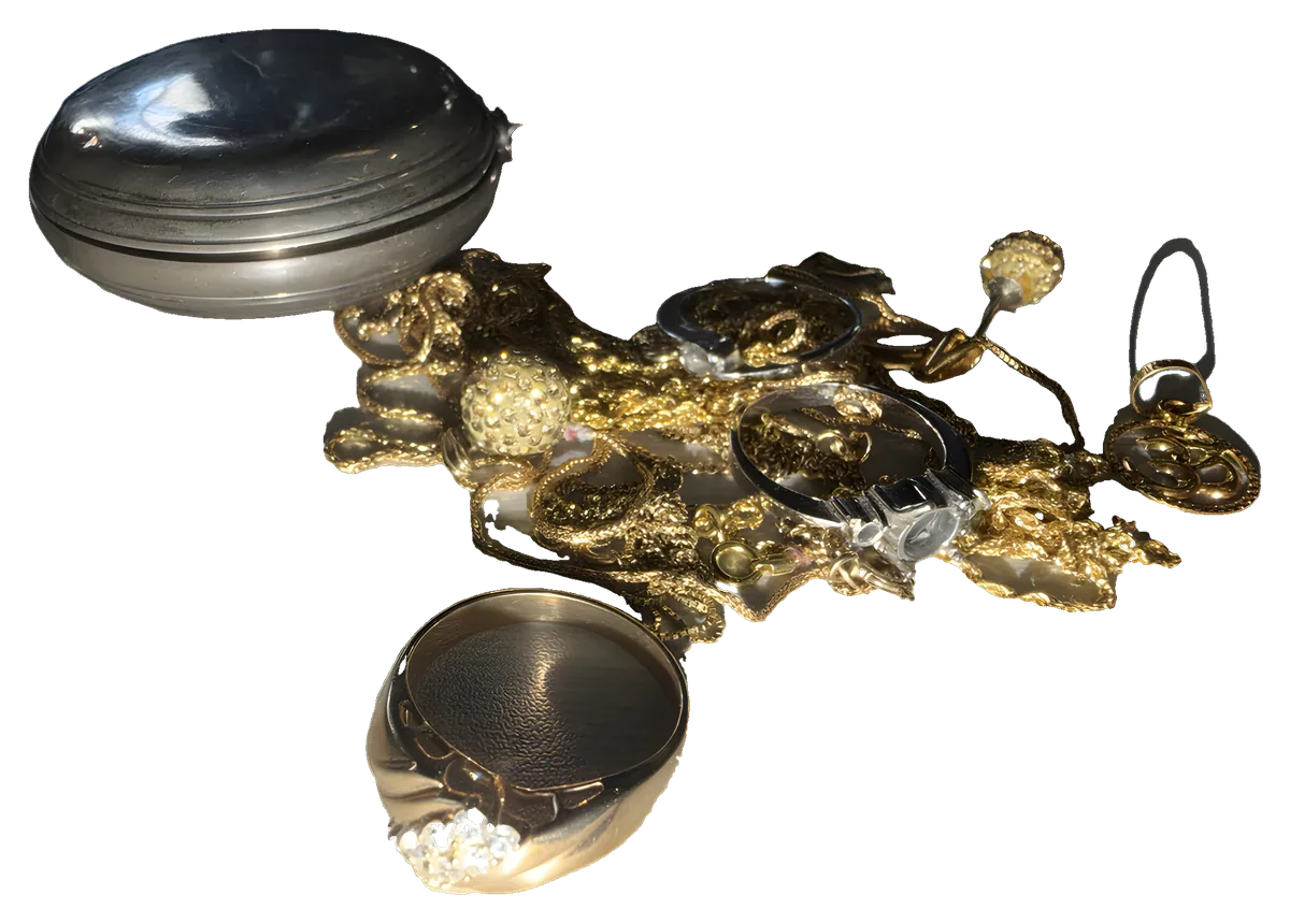 Gold jewellery laid out on the counter for weighing